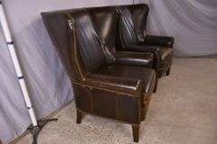 Pair of Paul Robert distressed brown leather wingback armchairs; 336-3831