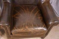 Pair of Paul Robert distressed brown leather wingback armchairs; 336-3831