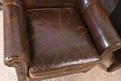 Pair of Paul Robert distressed brown leather wingback armchairs; 336-3831