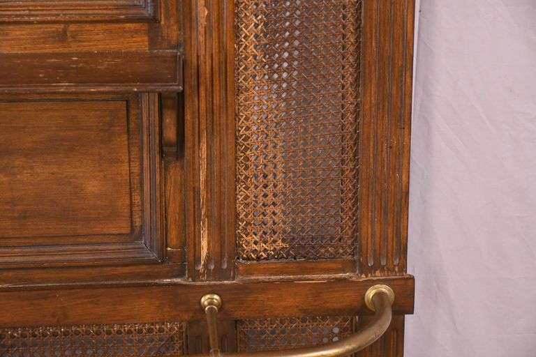 Carved walnut caned back hall tree with beveled mirror; 68-5329