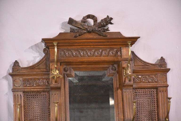 Carved walnut caned back hall tree with beveled mirror; 68-5329