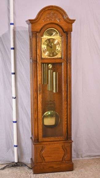 Howard Miller grandfather clock with oak case; 16748-006