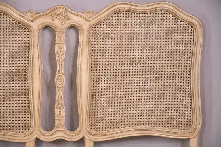 Carved off-white king size headboard with caned panels; 68-5251