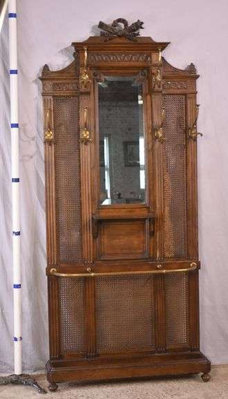 Carved walnut caned back hall tree with beveled mirror; 68-5329