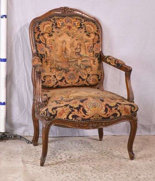 Carved French style open arm chair with needlepoint fabric; 55-11181