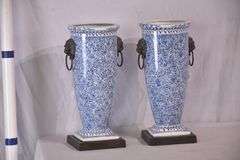 Pair of blue and white ceramic vases with bronze lion head adornments; 6117-017