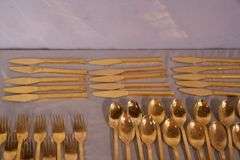 SRI "Royalty" gold toned stainless flatware set; 14-2666