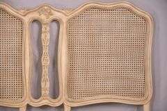 Carved off-white king size headboard with caned panels; 68-5251
