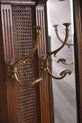 Carved walnut caned back hall tree with beveled mirror; 68-5329