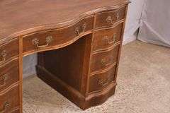 Mahogany serpentine front kneehole desk; 1148-008
