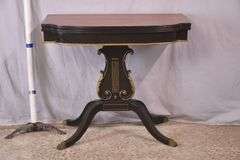 Mahogany flip-top game table with black and gold lyre pedestal base; 495-313