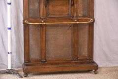 Carved walnut caned back hall tree with beveled mirror; 68-5329