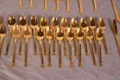 SRI "Royalty" gold toned stainless flatware set; 14-2666