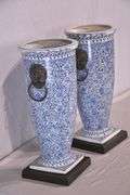 Pair of blue and white ceramic vases with bronze lion head adornments; 6117-017