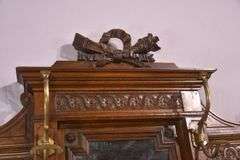 Carved walnut caned back hall tree with beveled mirror; 68-5329