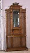 Carved walnut caned back hall tree with beveled mirror; 68-5329