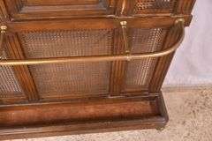 Carved walnut caned back hall tree with beveled mirror; 68-5329