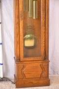 Howard Miller grandfather clock with oak case; 16748-006