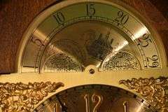 Howard Miller grandfather clock with oak case; 16748-006