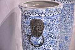 Pair of blue and white ceramic vases with bronze lion head adornments; 6117-017