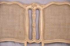 Carved off-white king size headboard with caned panels; 68-5251