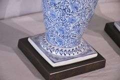 Pair of blue and white ceramic vases with bronze lion head adornments; 6117-017