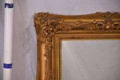 Mirror with ornate gold frame; 74-11631E