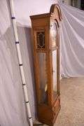 Howard Miller grandfather clock with oak case; 16748-006