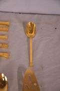 SRI "Royalty" gold toned stainless flatware set; 14-2666