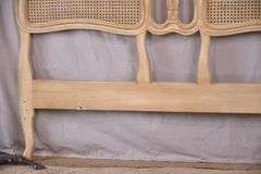 Carved off-white king size headboard with caned panels; 68-5251
