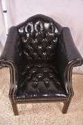 Painted black leather armchair with tufted back and seat; 336-4498