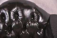 Painted black leather armchair with tufted back and seat; 336-4498