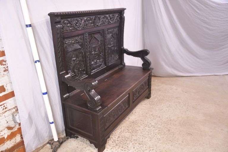 Carved oak bench with lift-top storage seat; 68-6821