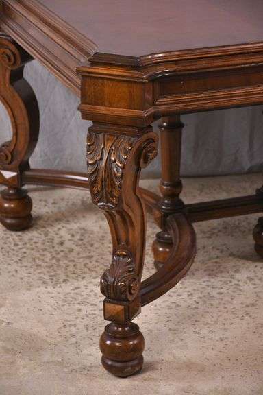 Carved walnut dining table with ornate trestle base; 74-12809D