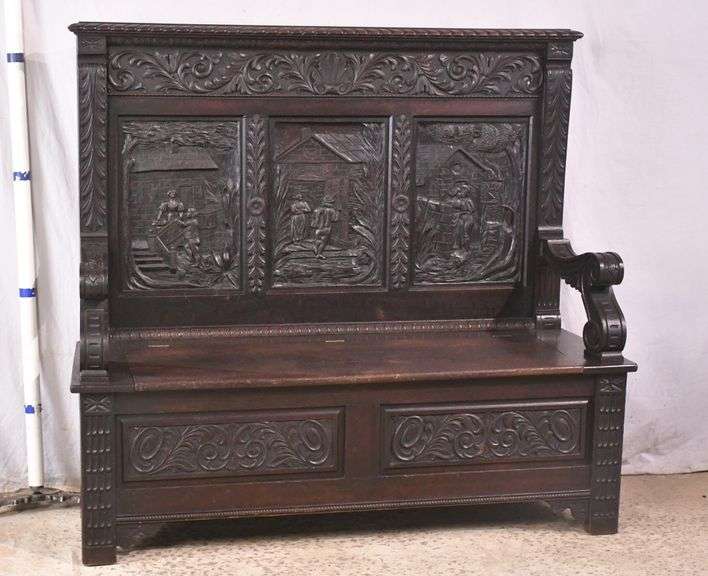 Carved oak bench with lift-top storage seat; 68-6821