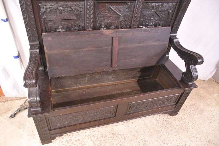 Carved oak bench with lift-top storage seat; 68-6821