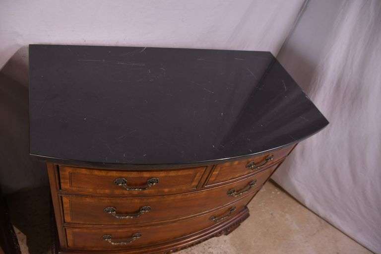 Pair of Universal carved mahogany bowfront bachelor's chests with black marble tops; 68-6869C