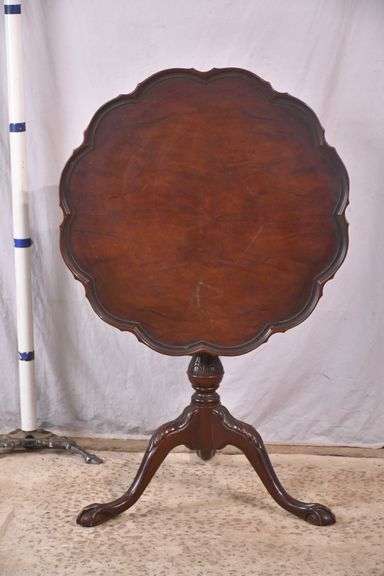 Carved mahogany tilt-top side table with ball in claw feet; 21-2749