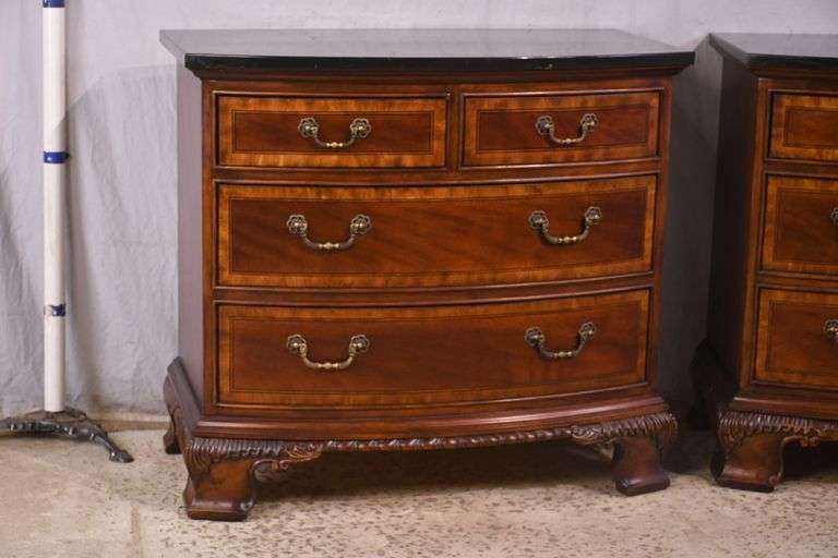 Pair of Universal carved mahogany bowfront bachelor's chests with black marble tops; 68-6869C