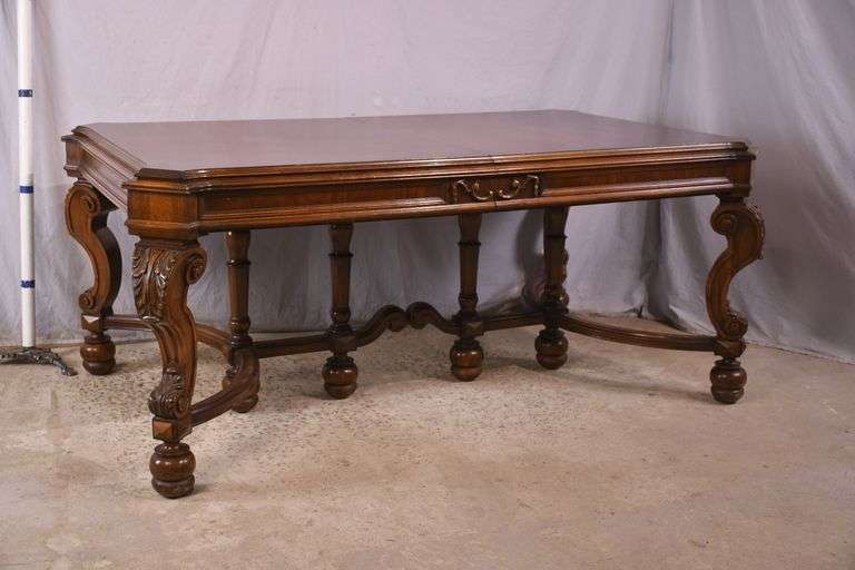 Carved walnut dining table with ornate trestle base; 74-12809D