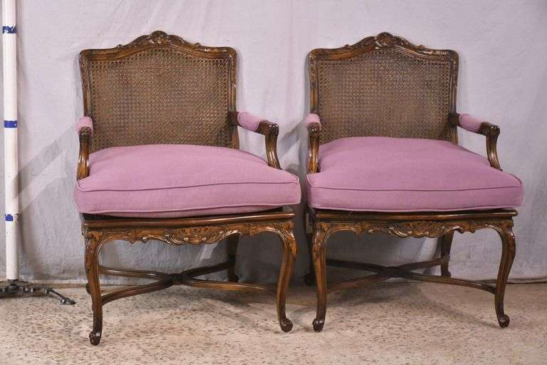 Pair of carved French style open armchairs with cane seats and backs; 68-6922