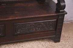 Carved oak bench with lift-top storage seat; 68-6821