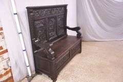 Carved oak bench with lift-top storage seat; 68-6821