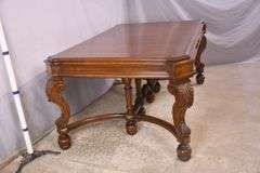 Carved walnut dining table with ornate trestle base; 74-12809D