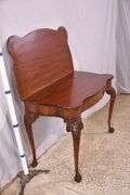 Carved mahogany flip-top table; 74-12753