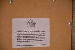 Carolina Mirror Co. large mirror with ornate black and gold frame; 1116-720