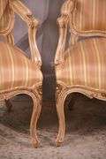 Pair of carved French style open armchairs with striped fabric; 68-6881