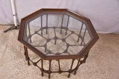 Mahogany octagonal glass top coffee table with cane-cut legs and stretchers; 68-6514