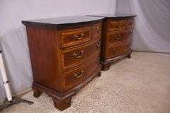 Pair of Universal carved mahogany bowfront bachelor's chests with black marble tops; 68-6869C