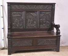 Carved oak bench with lift-top storage seat; 68-6821